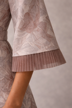 Soft blush pink jacquard gown with funnel sleeves