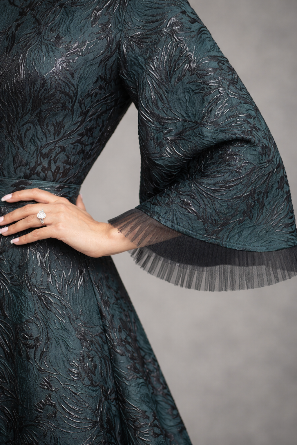 Green Jacquard gown with black accents and funnel sleeves