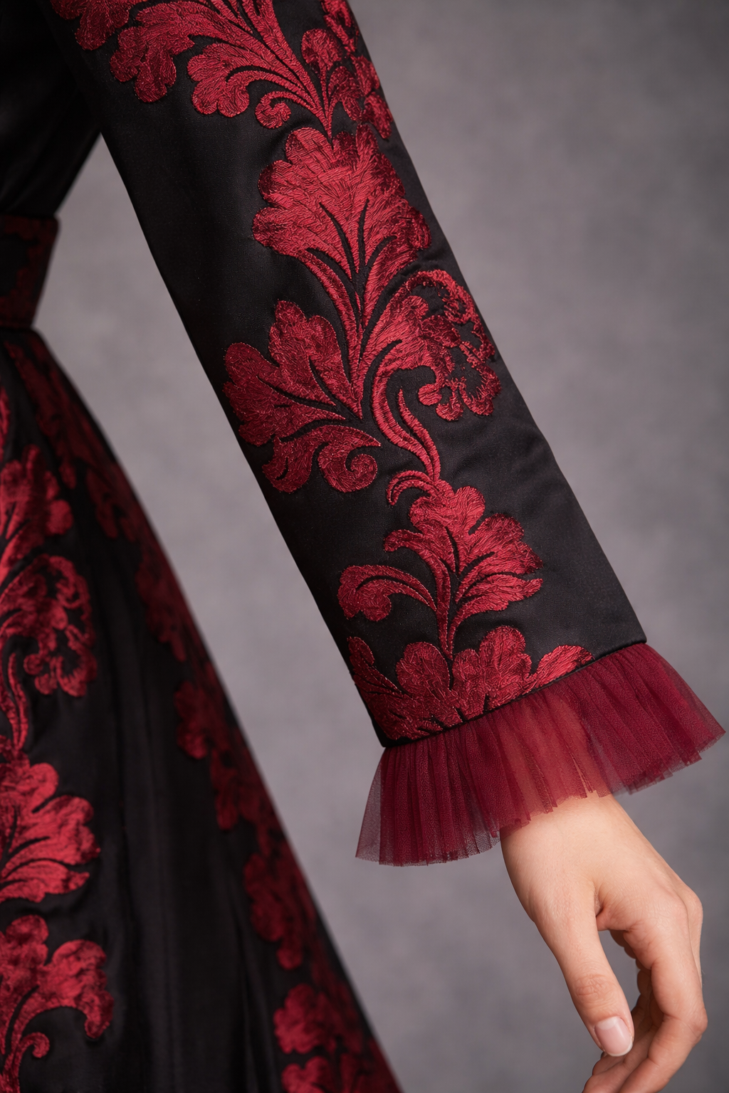 Black structured satin gown with deep burgundy motif and straight sleeves