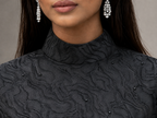 Matte black jacquard gown with funnel sleeves