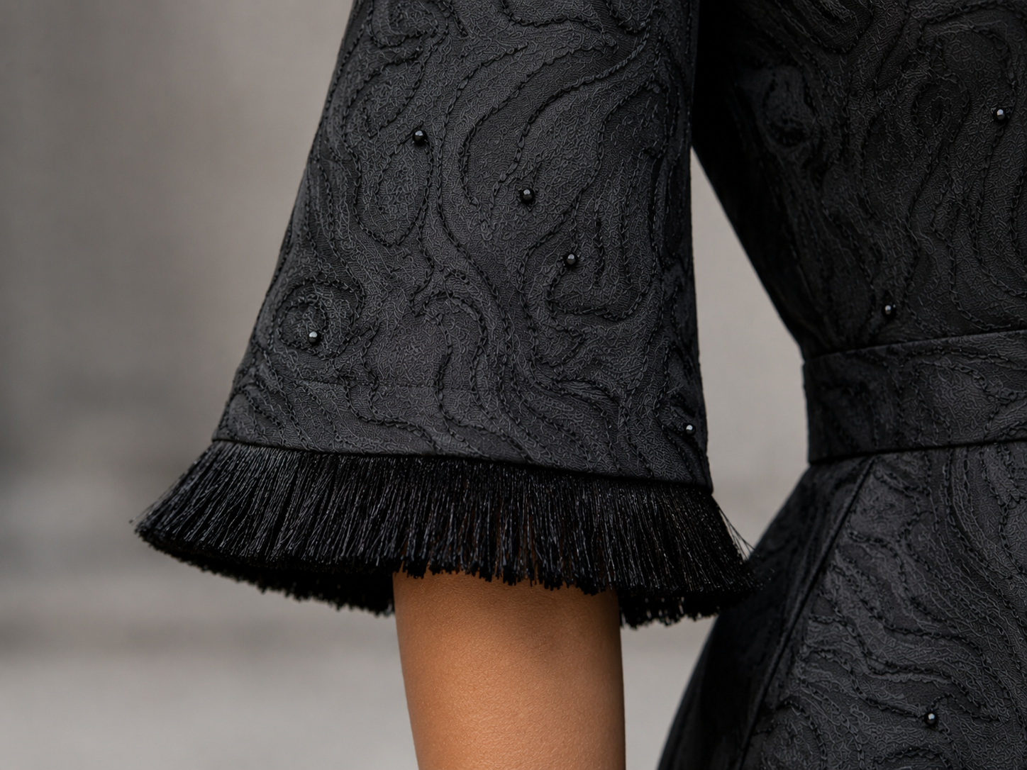 Matte black jacquard gown with funnel sleeves